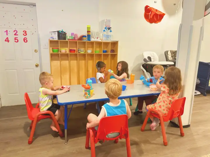 Children seated for snack and playtime in the daycare routine area