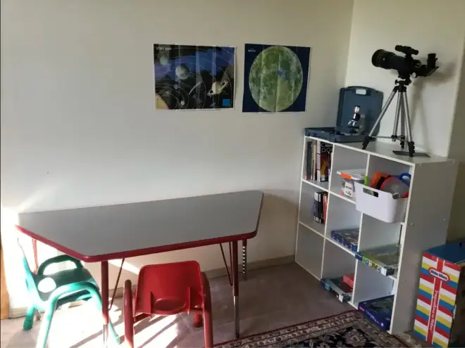 Learning corner with telescope, star maps, and books at Angel Family Daycare